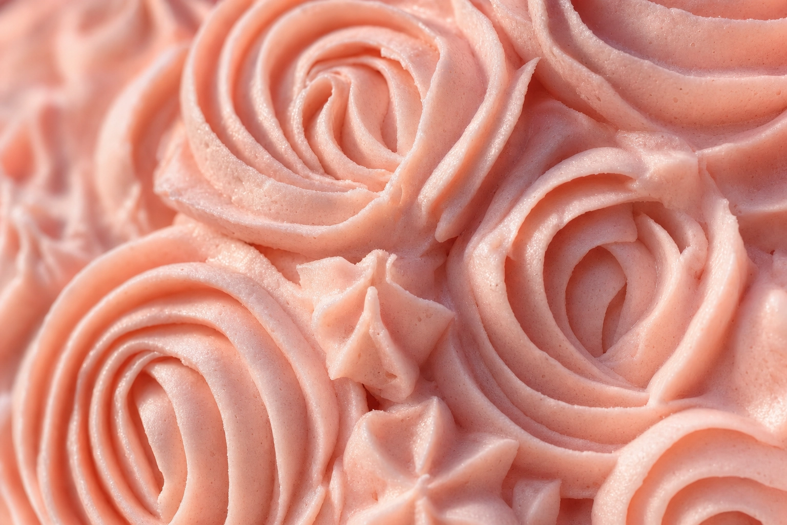 Macro close-up of pink buttercream rosettes with grazing light revealing piping texture — buttercream cake photography