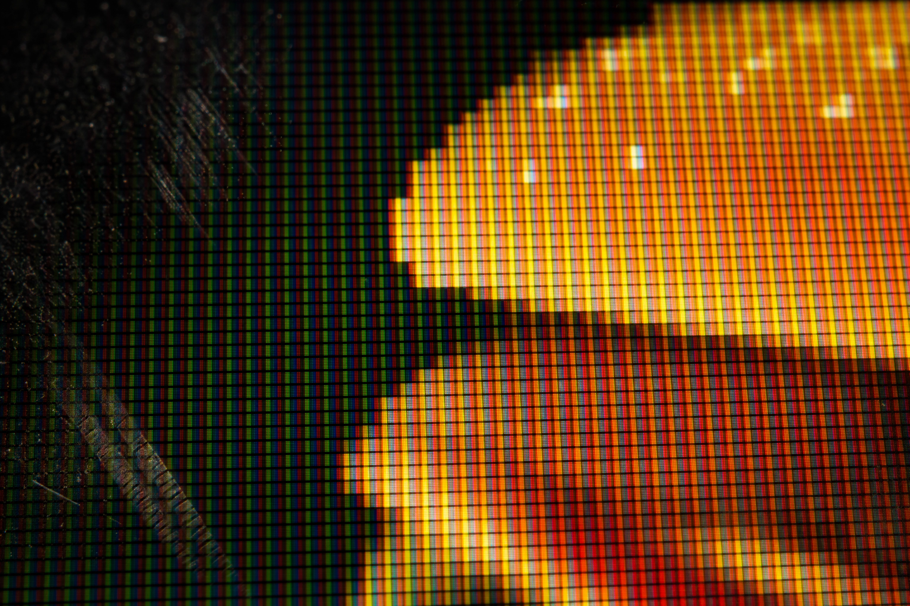 Macro of a menu board screen surface showing subpixels and compression artefacts across a burger photo