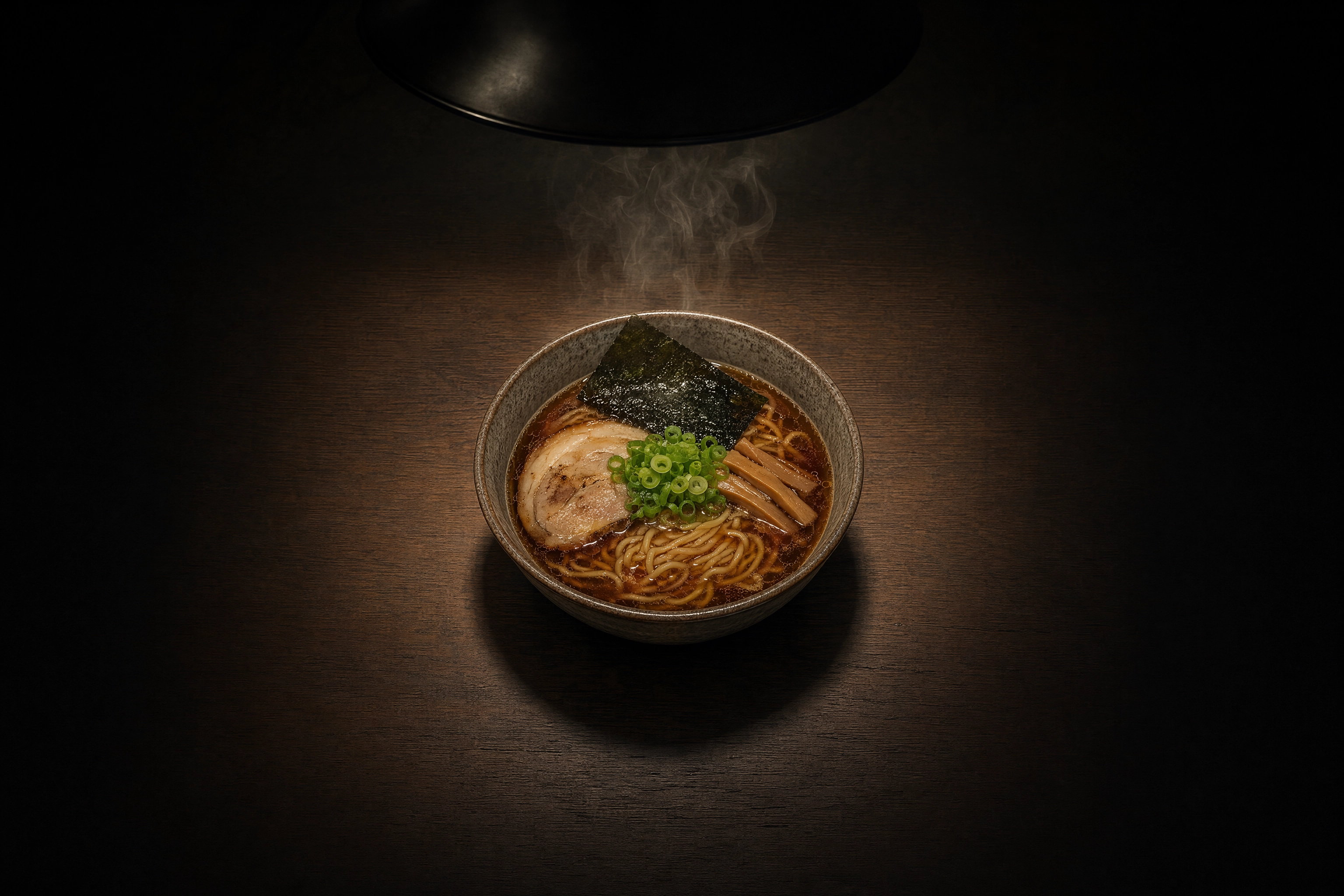 Ramen bowl centered in a circular pool of pendant light on a dark table, showing the centered square crop DoorDash renders for menu thumbnails