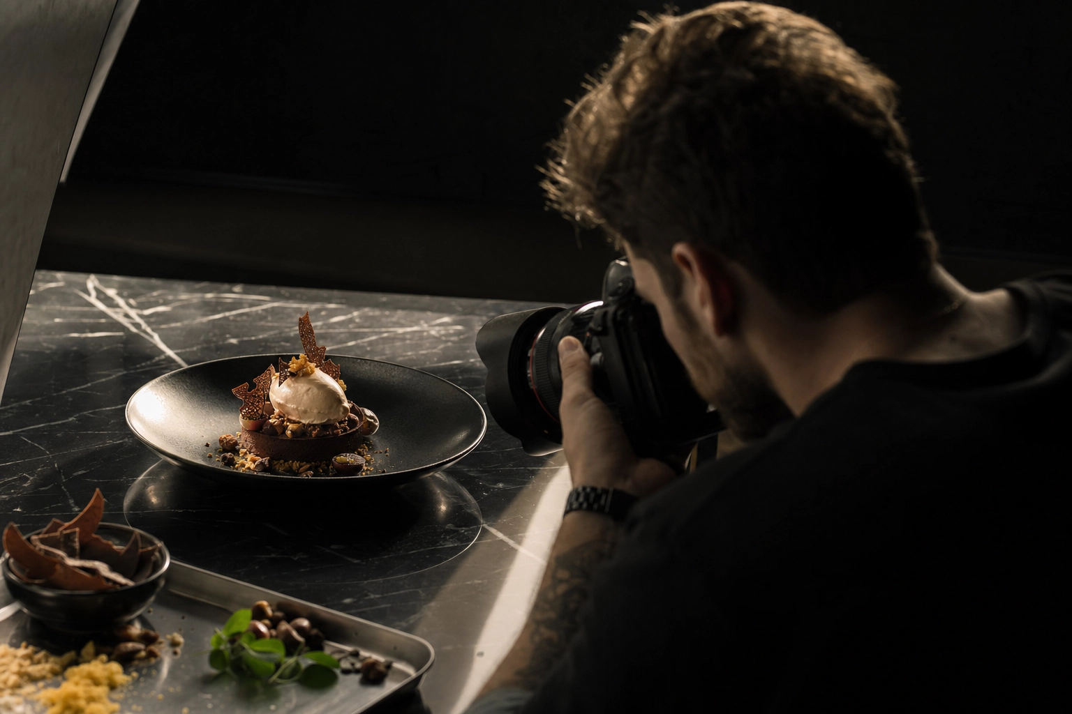 Food photographer in Dubai shooting a signature fine-dining dessert under dramatic lighting