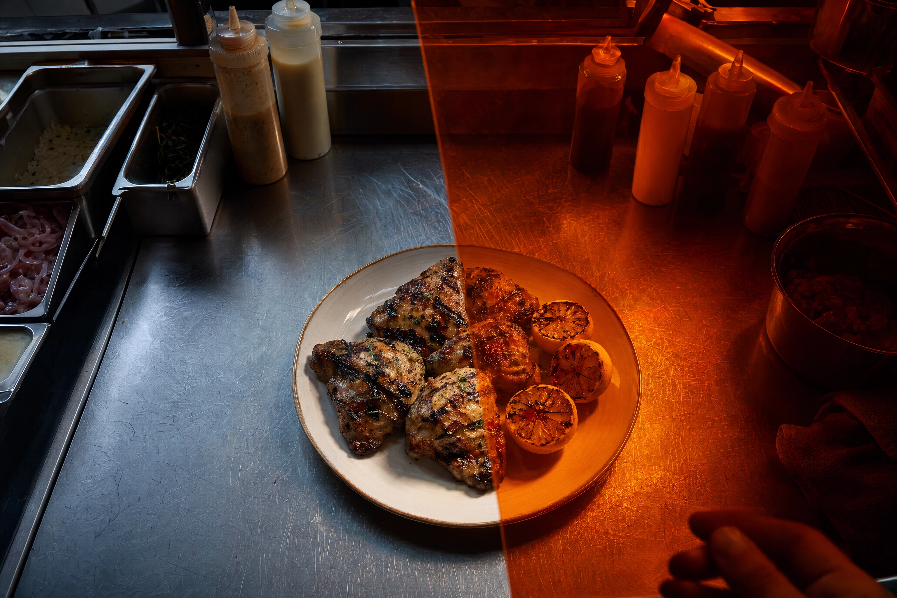 Orange lighting gel tinting half a plated dish and the kitchen clutter behind it, showing how photo filters shift every pixel equally