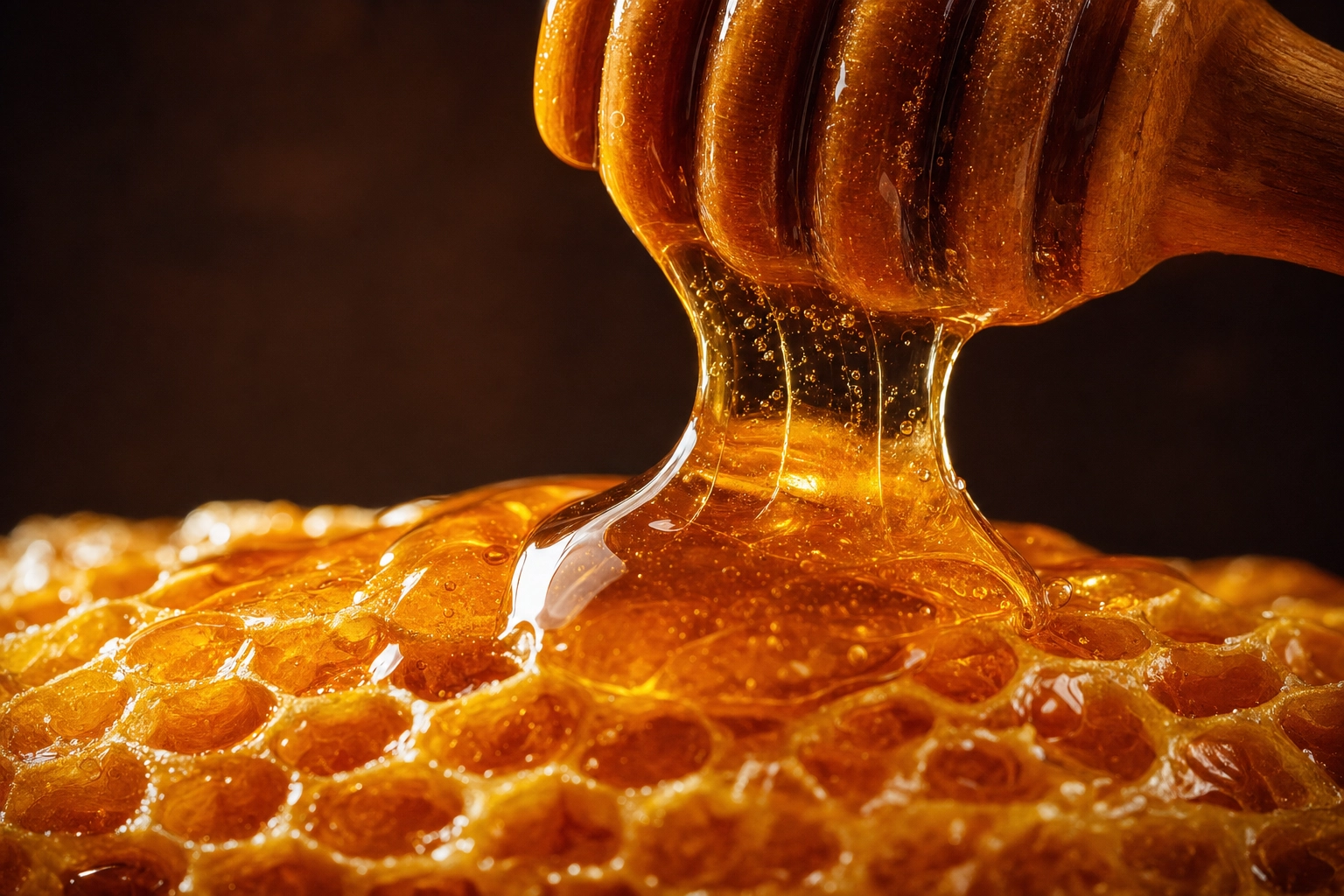 Macro beauty detail shot of golden honey pouring onto honeycomb, the appetite-driving food product photography hero
