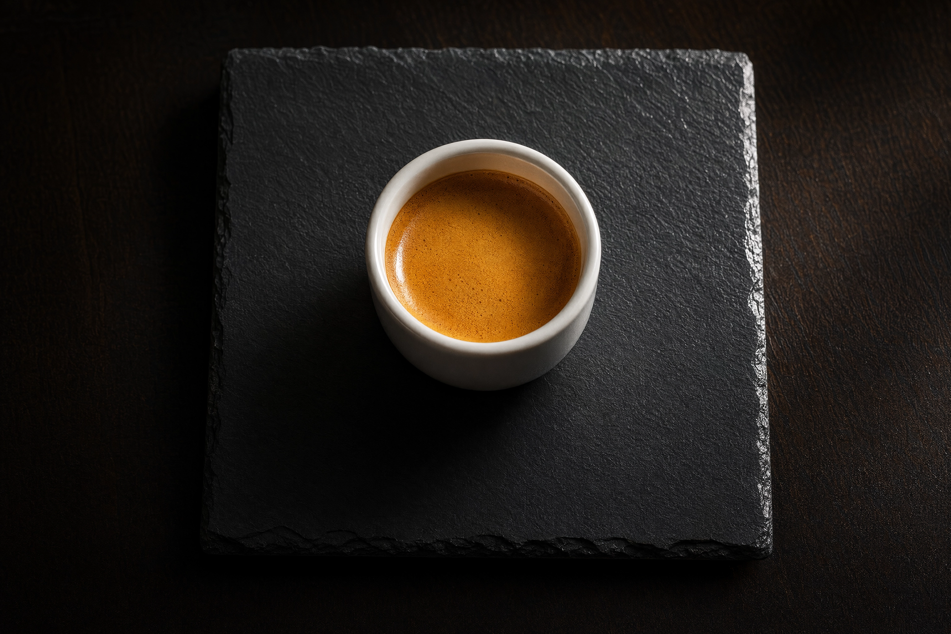 Round espresso cup centred on a square slate tile with wide even margins, illustrating a circular logo on Grubhub's 200x200 square artboard