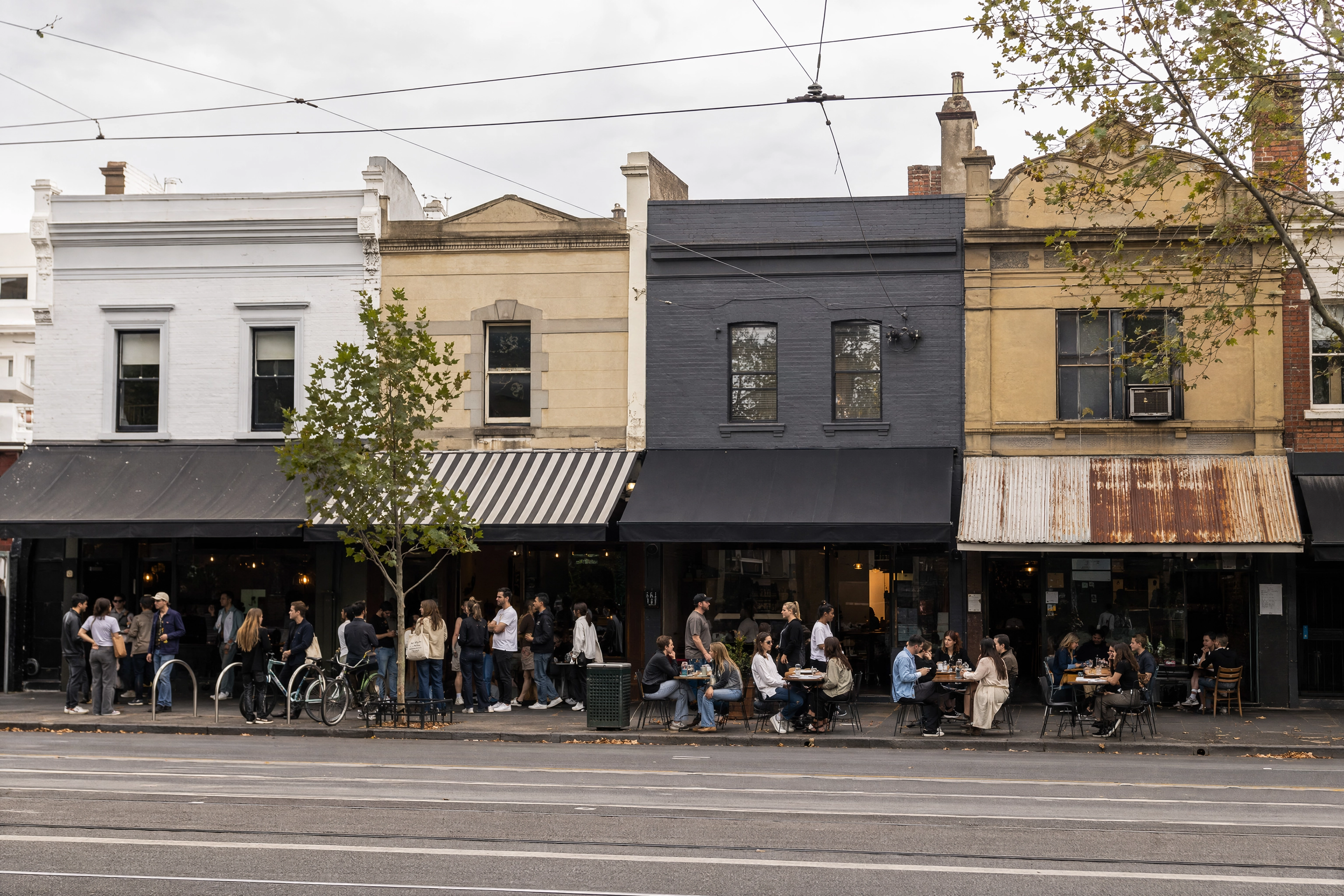 Row of competing independent cafes on a Melbourne street showing the density that drives food photography demand