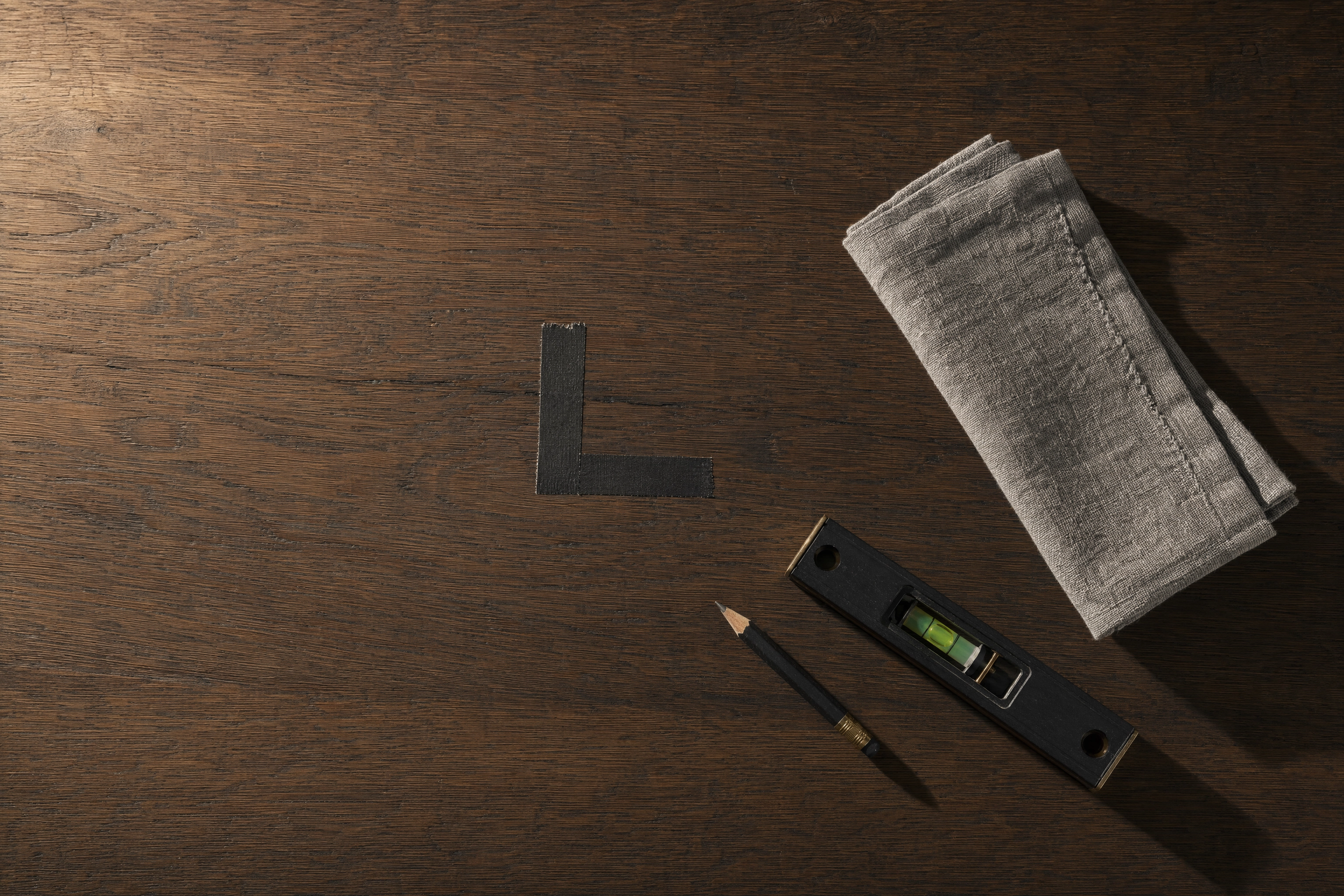Gaffer tape register marks on a table for repeatable plate placement in overhead food photography