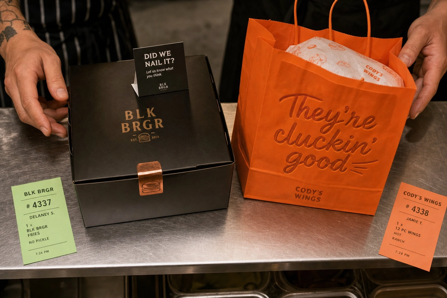 Overhead view of two distinct virtual brand delivery orders ready for pickup at a restaurant kitchen pass