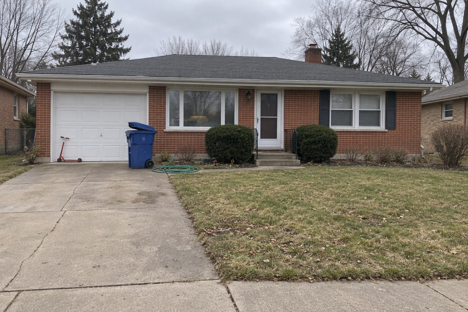 Brick ranch house driveway with a blue recycling bin and garden hose, clutter an agent names for removal before listing