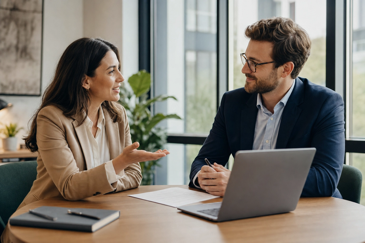 Two colleagues reaching a clear decision during a focused English business meeting at a sunlit table