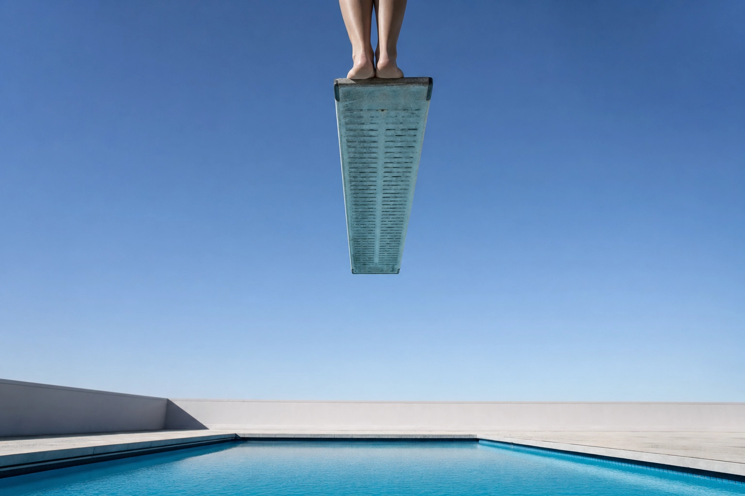 Bare feet hesitating at the edge of a high diving board, a metaphor for freezing before speaking despite knowing the words