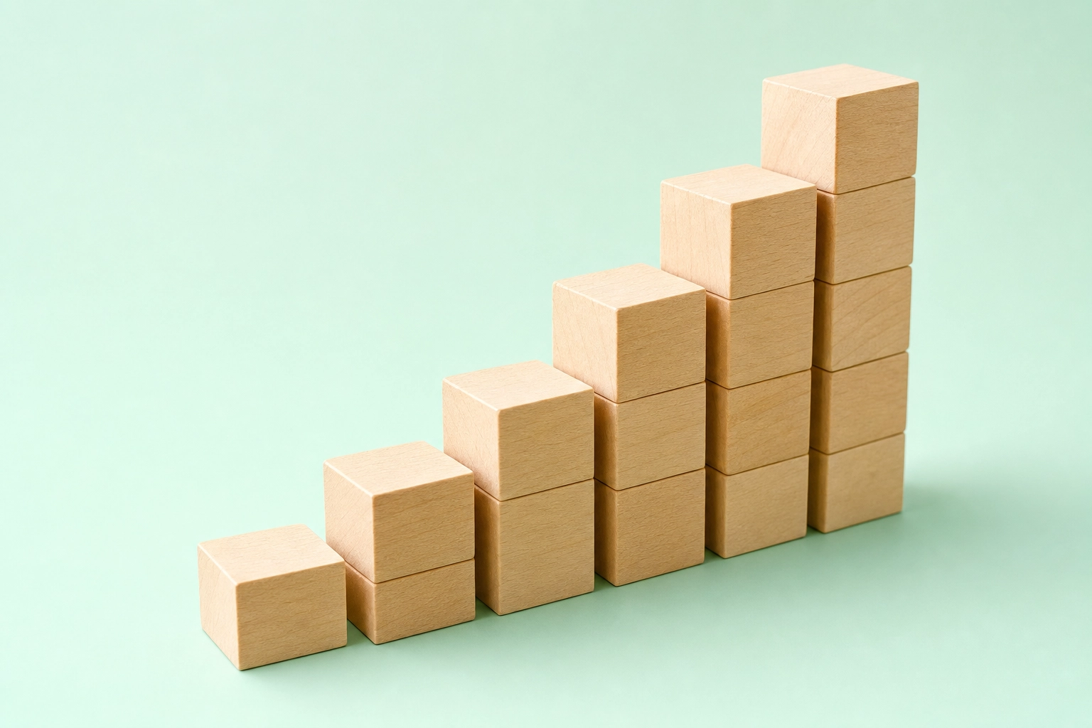 Ascending natural-wood blocks forming a staircase, symbolizing Rosetta Stone's structured step-by-step learning path