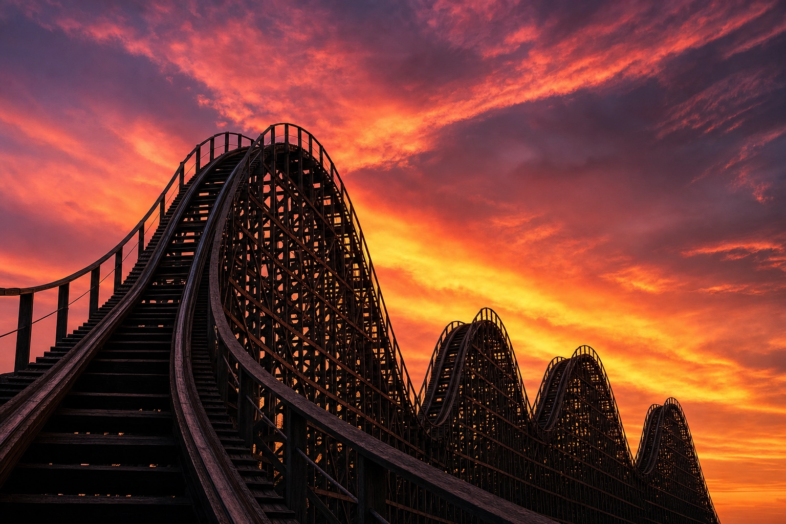 Roller coaster track rising and falling against a vivid sunset sky, a metaphor for the rise and fall of English intonation